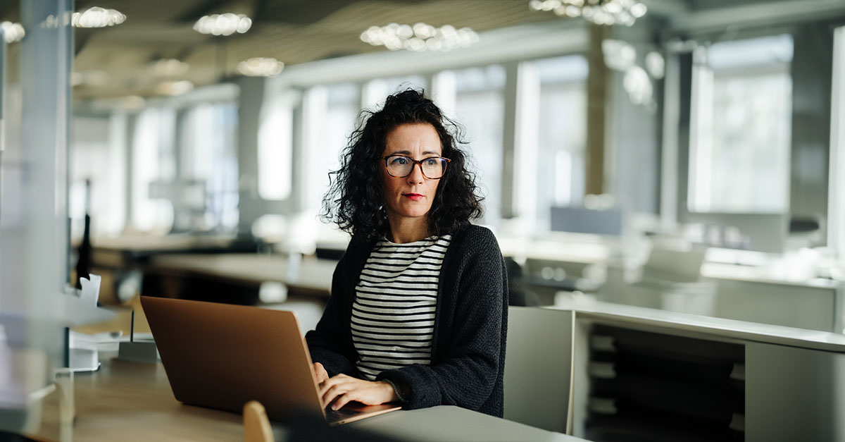 woman at a desk with a laptop